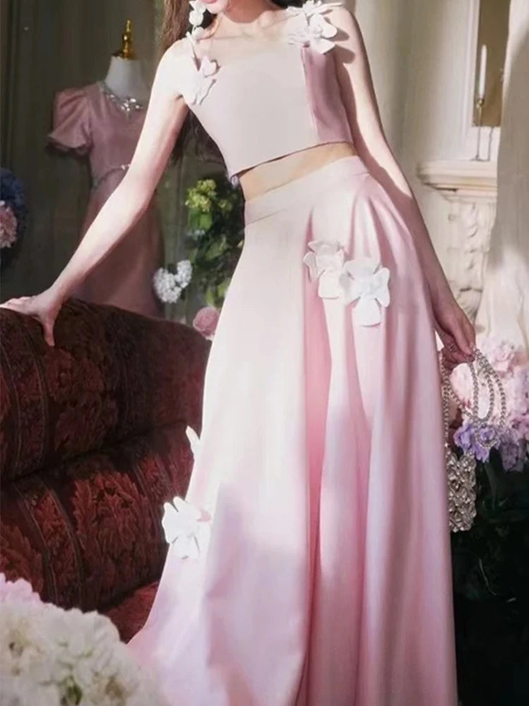 Pink evening gown with floral details in a decorated room.