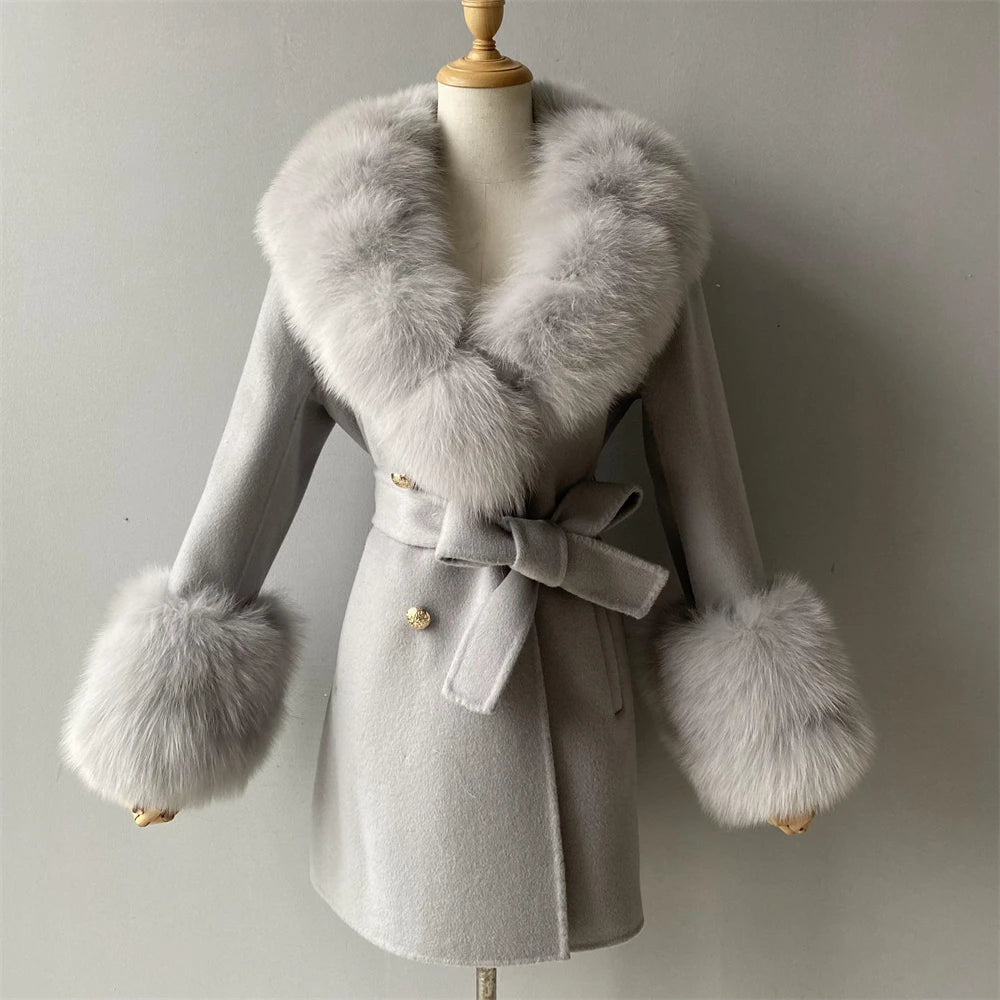 Gray coat with fur accents on a mannequin against a plain background