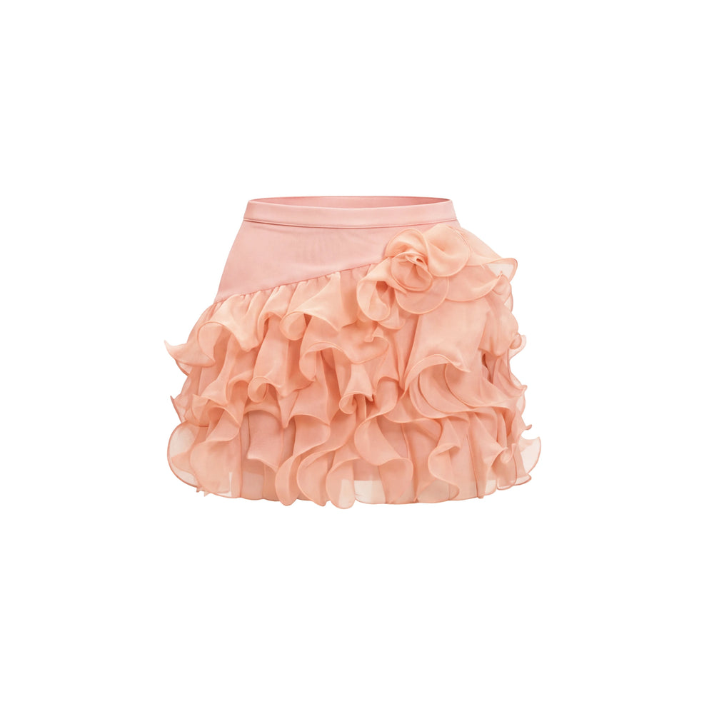 Detail of the ruffled mini skirt with a floral accent