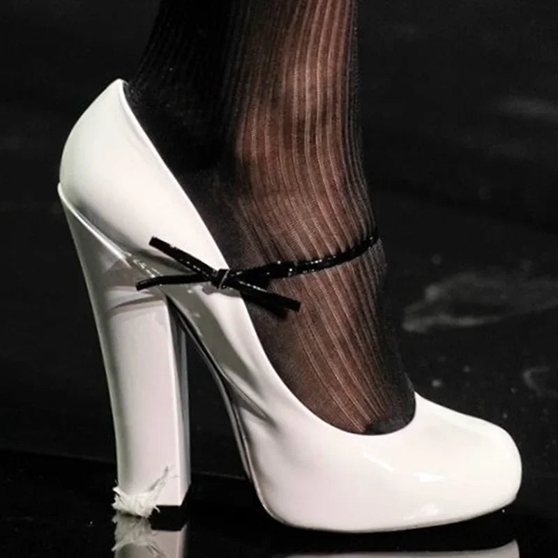 White patent leather square heel pump with ankle strap