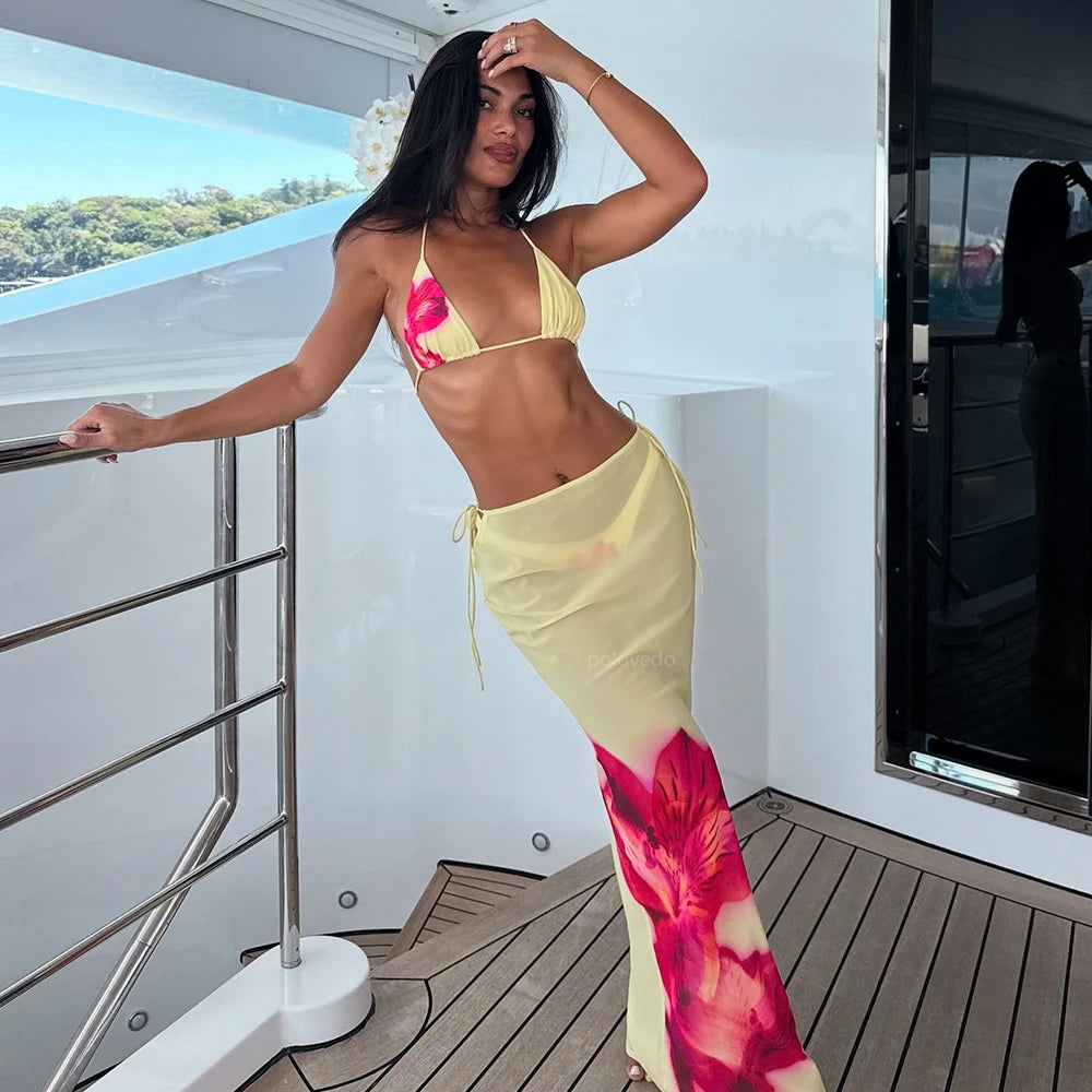 Woman in a colorful bikini and sarong on a boat deck