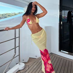 Woman in a colorful bikini and sarong on a boat deck