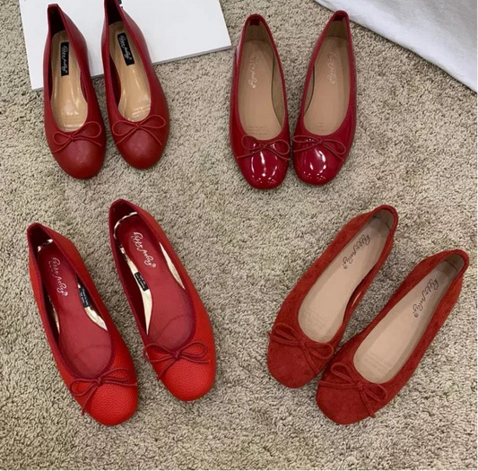 Red ballet flats with a bow detail and round toe.