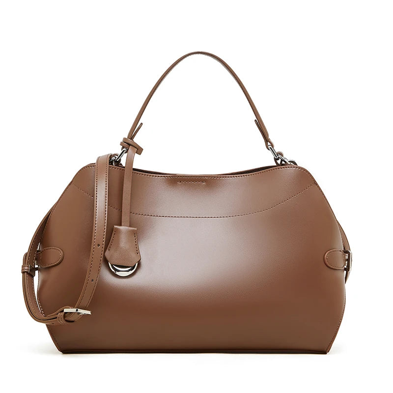 Brown handbag with a shoulder strap on a white background