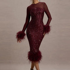 Magenta dress with feathered details on a plain background