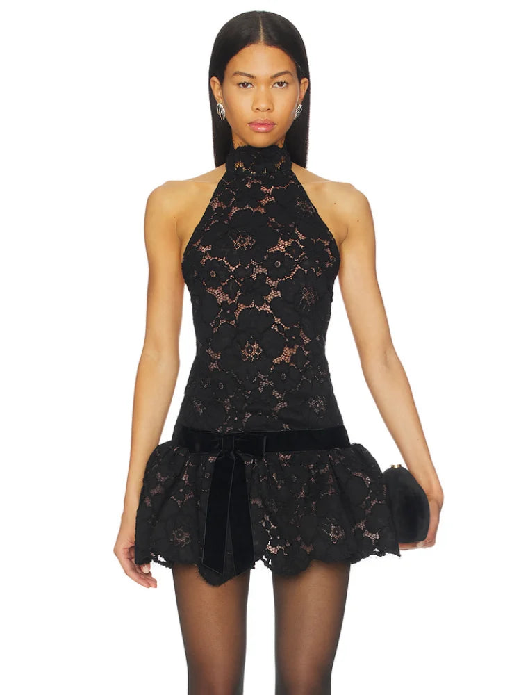 Model wearing a black lace halter neck mini dress with accessories.