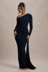 Woman wearing a navy off-shoulder gown against a beige background
