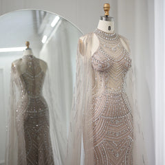 Mannequin displaying the Sharon Said caramel mermaid gown, showcasing its flattering silhouette and graceful train. Golden Atelier 3