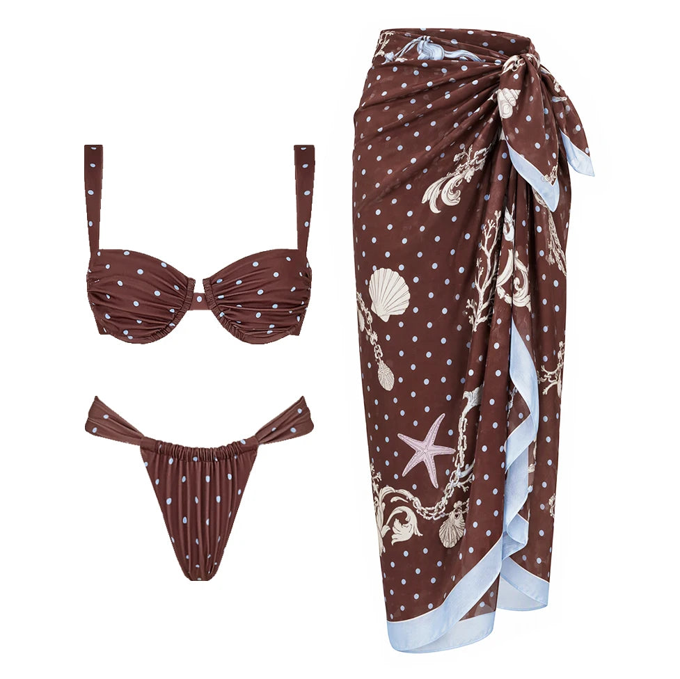 Two-piece polka dot bikini with ruched details and contrast trim, featuring a sweetheart-style bustier top and tie-side bottoms, paired with a coordinating polka dot skirt.