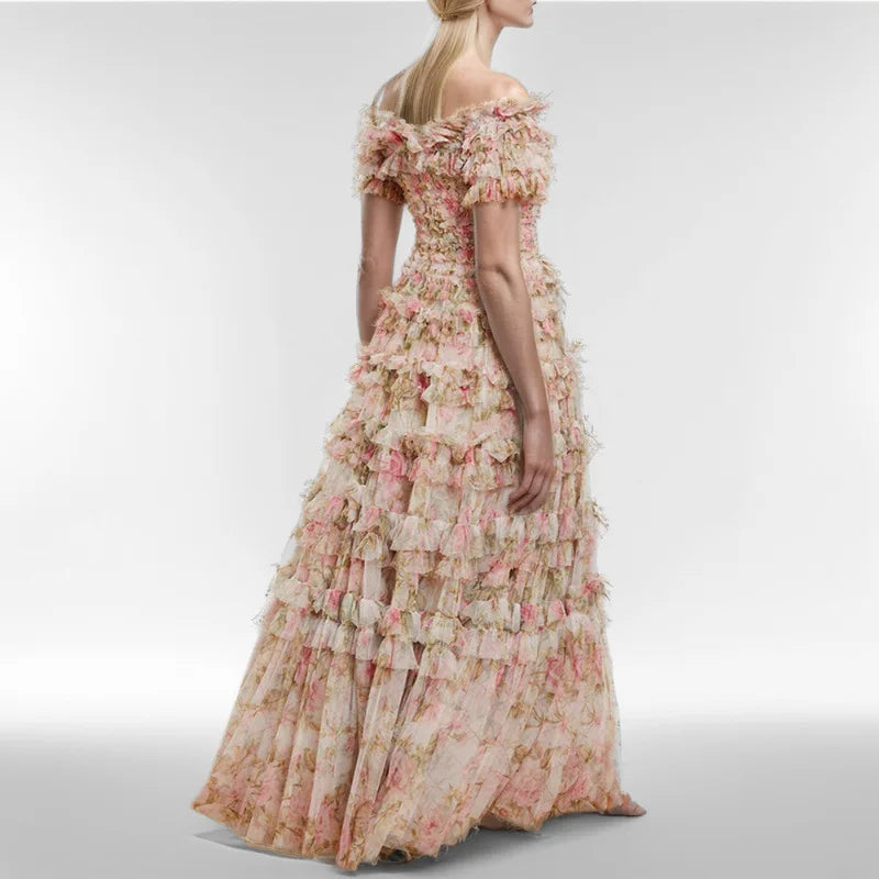 Woman wearing a floral off-shoulder gown on a plain background