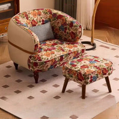 Floral-patterned armchair and ottoman on a checkered rug