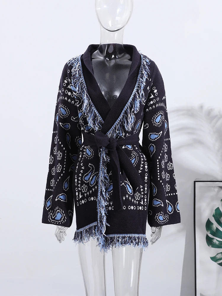 Black cardigan with blue paisley pattern on a mannequin against a white background