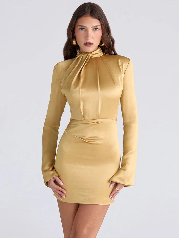 Woman wearing a gold dress against a light gray background