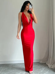 Woman wearing a red dress with a plunging neckline, standing against a neutral background.