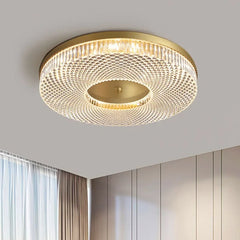 A modern round acrylic ceiling light with LED lights, illuminating a contemporary living room.