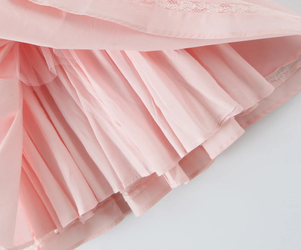 Close-up of a pink tulle skirt on a light gray background