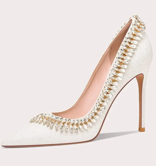 White high-heeled shoe with decorative elements on a white background