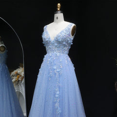 Light blue evening gown on a mannequin against a black background