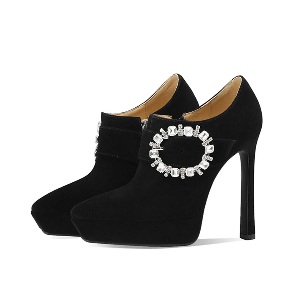 Close-up of black stiletto heel bootie detail