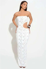 Woman wearing a white strapless dress with cut-out design on a white background