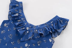Close-up of ruffled V-neck on a sleeveless A-line mini dress