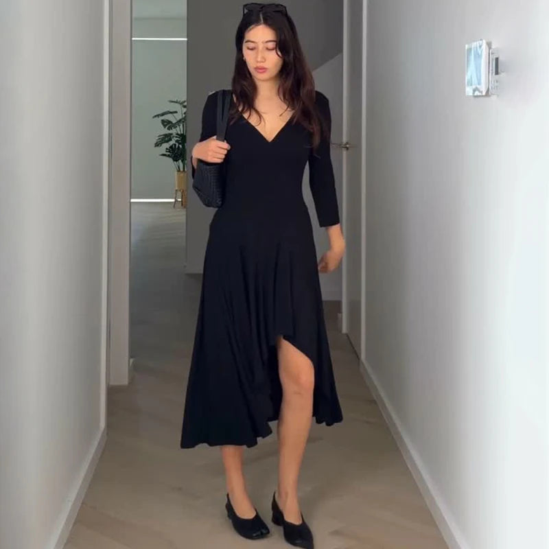 Black V-neck irregular hem midi dress interior hallway