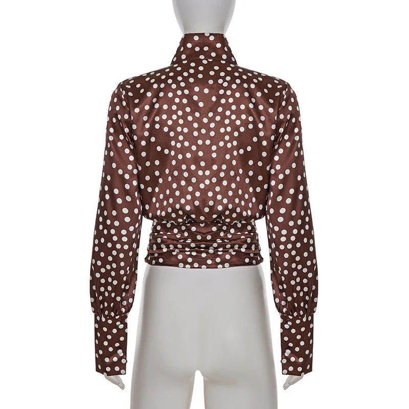 Back view of blouse illustrating lantern sleeve shaping and relaxed torso structure.