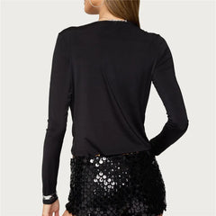 Black long-sleeve top worn by a person on a light gray background