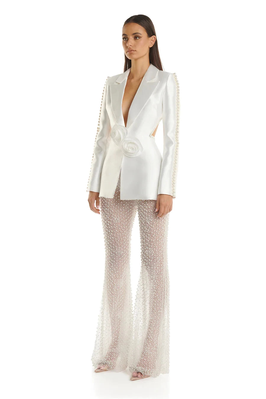 Woman wearing a white blazer and patterned pants
