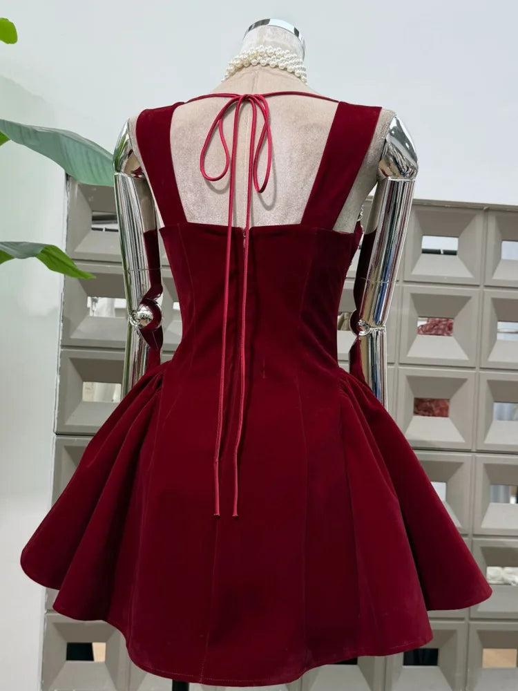 Red dress with open back on a mannequin against a white background