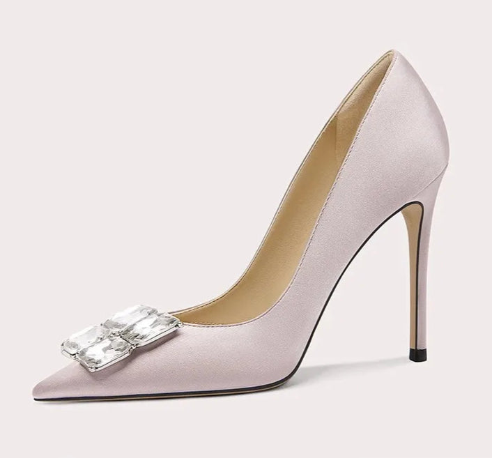 High-heeled shoe with a decorative bow on a light gray background