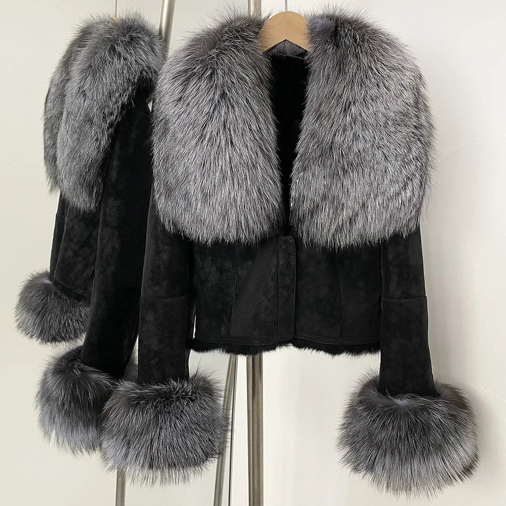 Black coat with gray fur trim on a hanger against a white background
