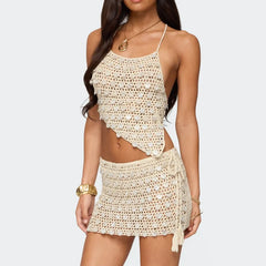 Woman wearing a beige crochet top and skirt set on a white background