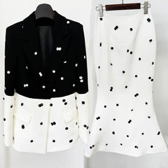 Black and white outfit with polka dot pattern on a plain background
