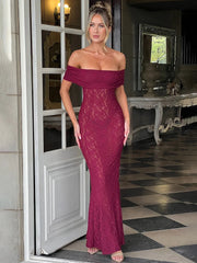 Woman wearing a burgundy lace off-shoulder gown in an elegant interior setting.