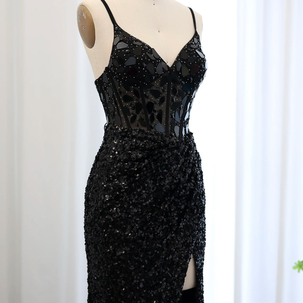 Black beaded evening gown on a mannequin against a white background