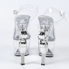 Clear high-heeled sandals with rhinestone embellishments on a white background