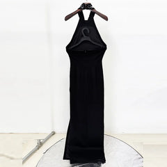Black dress on a hanger against a white background