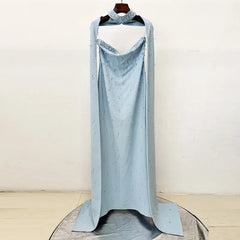 Strapless long gown with diamond embellishments and detachable cape displayed.