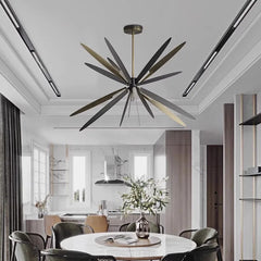 Sleek modern pendant lights hanging above a dining room table, creating a sophisticated atmosphere. Golden Atelier 4