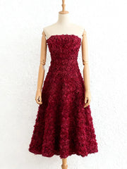 Elegant 3D floral burgundy gown styled for evening events