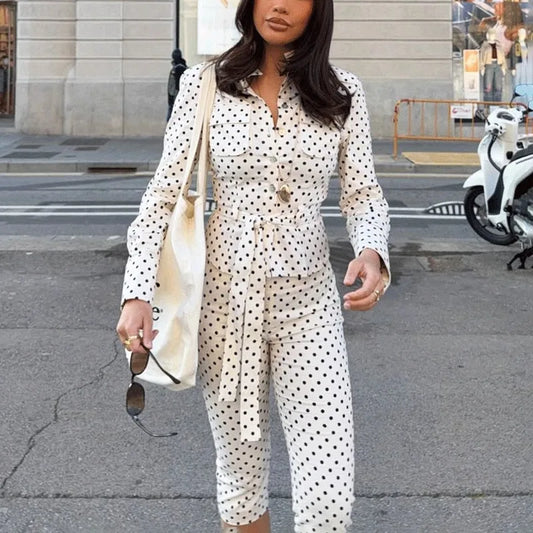 Woman wearing a polka dot button-up shirt and cropped pants set
