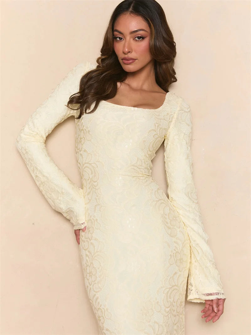 Woman wearing a white lace dress against a beige background