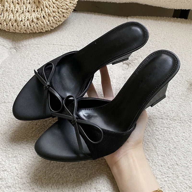 Black bow wedge mules