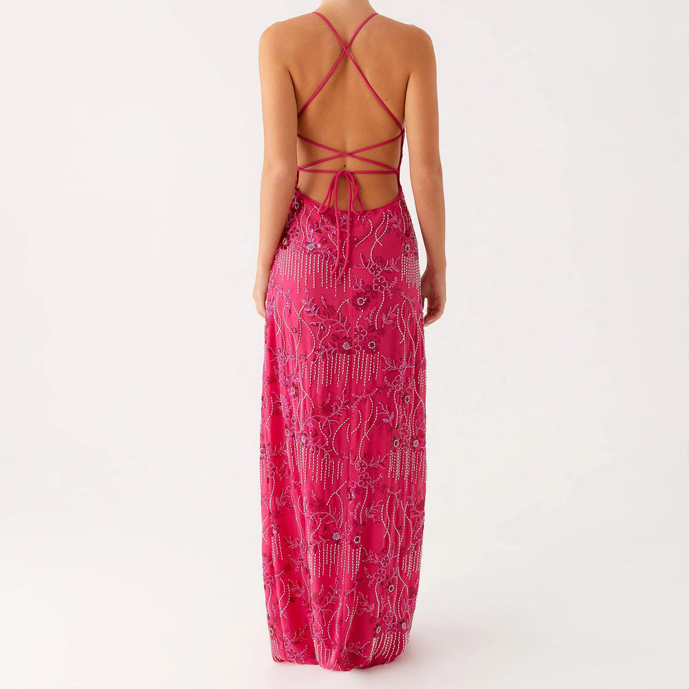 Pink patterned dress with open back on a white background