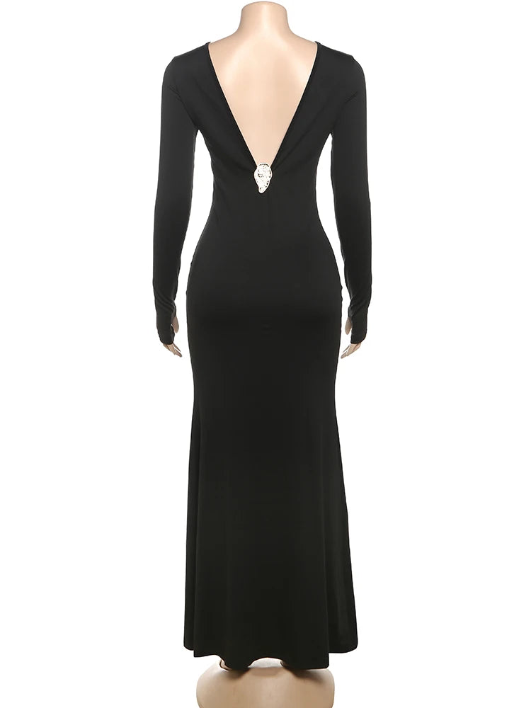 Black evening gown with long sleeves on a mannequin against a white background