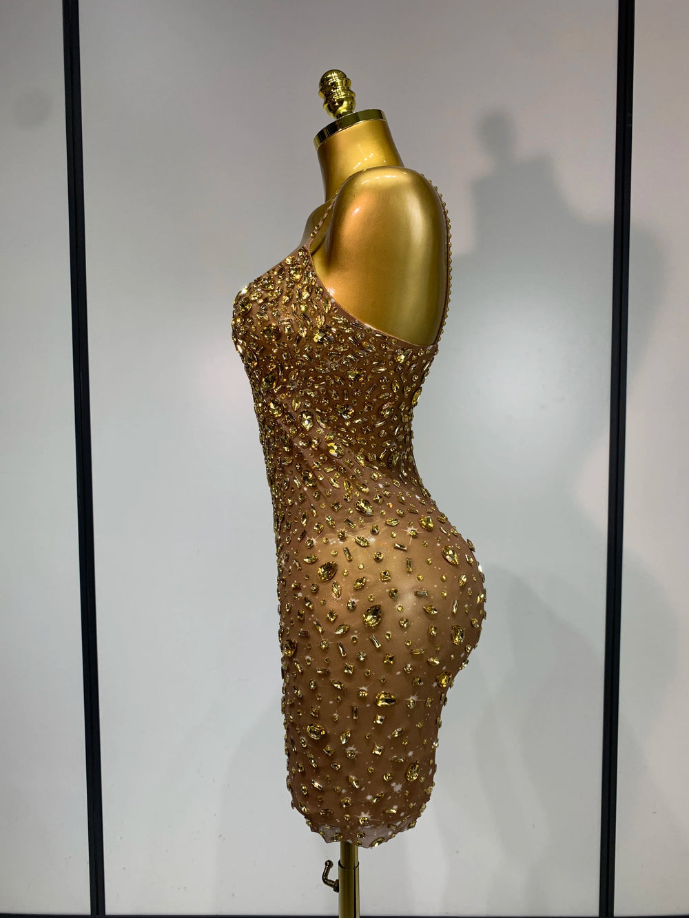 Back view of gold embellished sheer mini dress