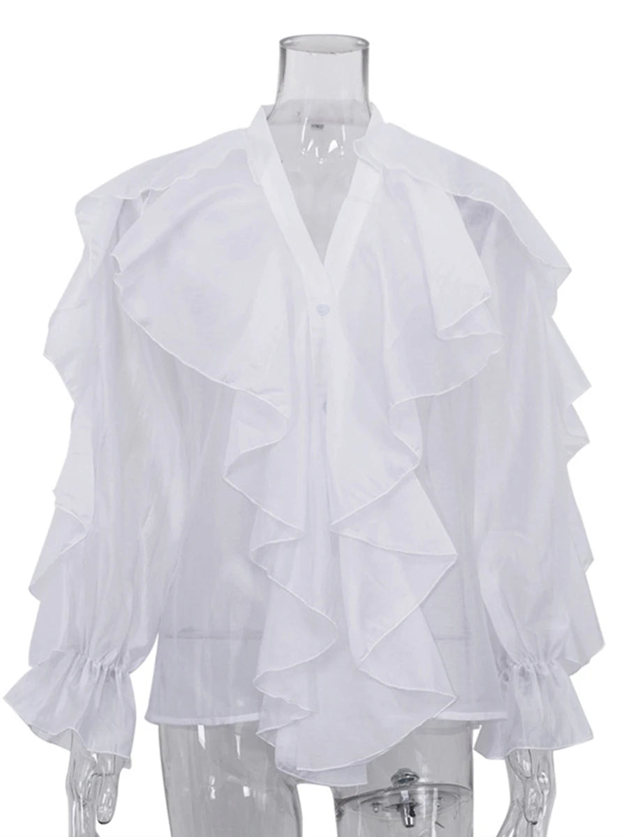 White ruffled blouse on a mannequin against a white background