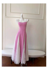 Full view of a pink spaghetti strap A-line midi dress with white lace insets.