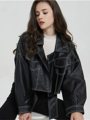 A woman wearing a black faux leather jacket with a split hem, showcasing its edgy style. Golden Atelier 4